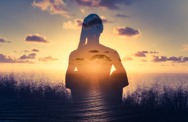 istock Woman meditating at sunset. 1307266250