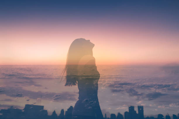 istock Woman relaxing outdoors at sunset 1307266258