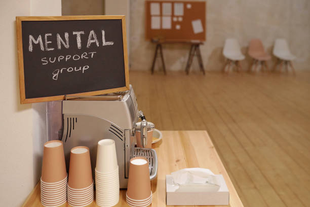 istock Small blackboard with notice saying mental support group standing on coffee machine 1307266649