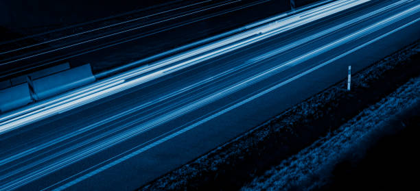 istock blue car lights at night. long exposure 1307267626
