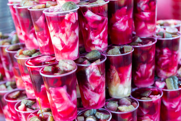 Traditional Turkish pickled vegetables in sour brine Tursu suyu in street market Traditional Turkish Torshi (Tursu suyu), pickled vegetables in sour brine from turnip in plastic cups for sale in street market pickled turnip stock pictures, royalty-free photos & images