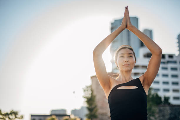 istock Female doing yoga outdoors in city 1307268703