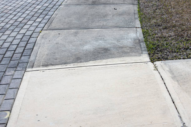 patrially cleaned and partial irty cement sidewalk in front of a homeafter some of it has been pressure washed. - irty imagens e fotografias de stock