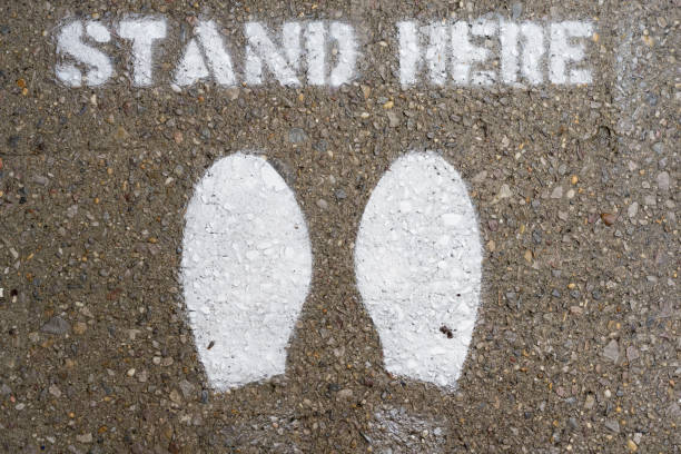 istock Stans Here - Coronavirus Distancing Sign on NYC Sidewalk 1307270181