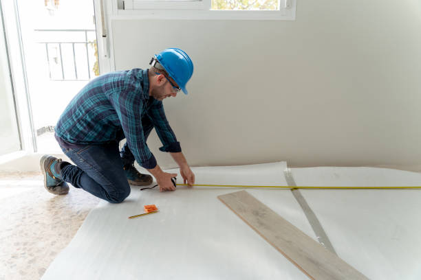 istock Carpenter worker installing laminate flooring in the room 1307271144