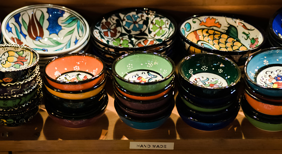 Vertical photo of handicraft pottery items at a market stall
