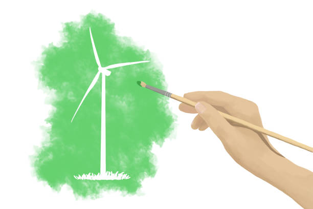 A woman's hand holding a paintbrush, painting a wind turbine sustainable resources landscape in green color with a white background.  This is a concept for futuristic global energy solutions and renewable power generation ideas.