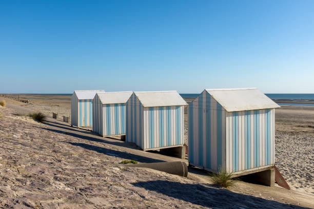Striped beach cabins in Hardelot, France. stock photo