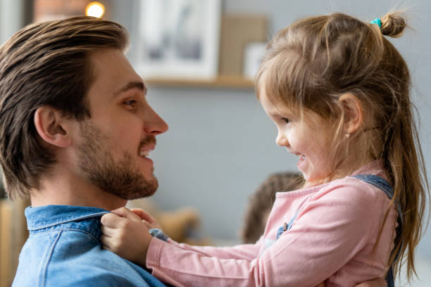 istock Portrait of handsome father and his cute daughter hugging and smiling. 1307274607