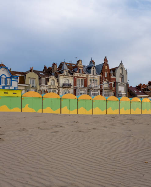 Colorful beach huts in front of historic seaside buildings in Dunkirk, France stock photo