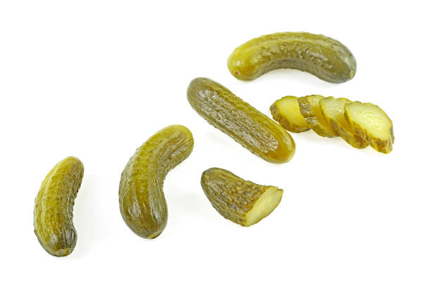 istock Delicious marinated pickled cucumbers isolated on a white background, top view. Pickled cucumbers and slices. 1307276165