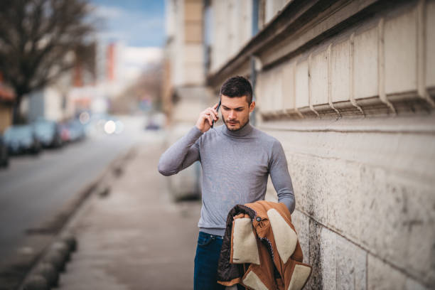 istock A businessman using a cell phone in the city 1307276400
