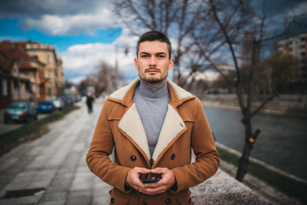istock A businessman using a cell phone in the city 1307276410