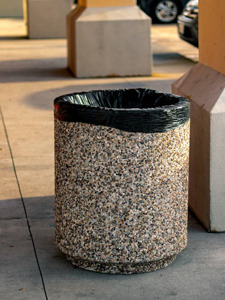 Trash can next to post at a strip mall