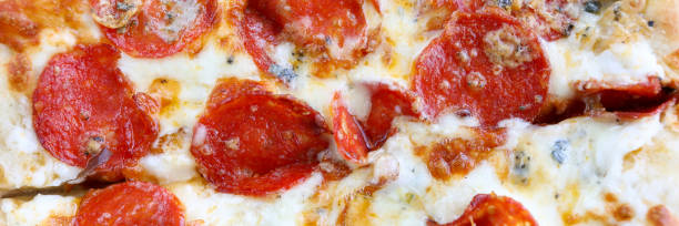 Fresh baked pizza with crusty cheese and hot tasty pepperoni ready to eat
