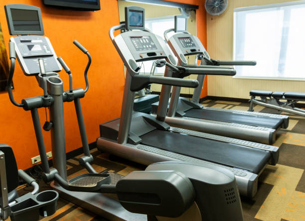 istock Treadmills and elliptical machines in a small gym 1307278285