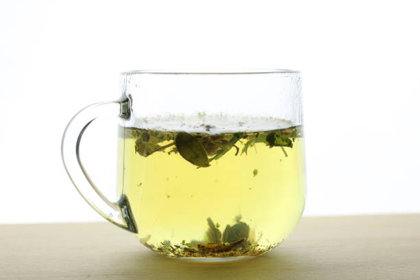 tee with herbs in transparent cup