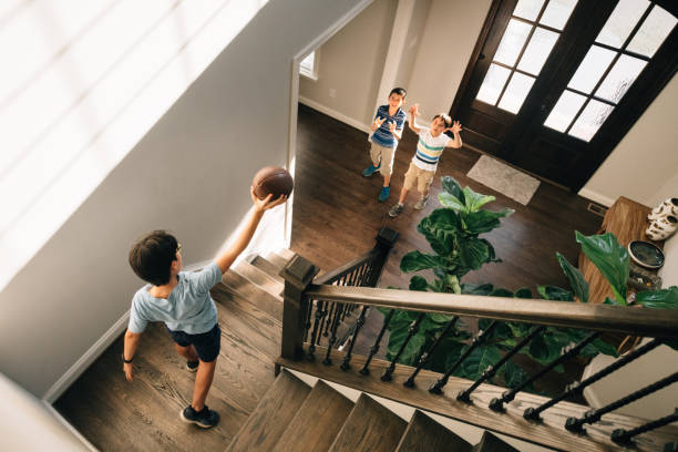 istock Kids playing football inside the house 1307278664