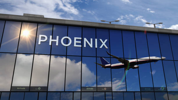 istock Airplane landing at Phoenix Arizona mirrored in terminal 1307279031