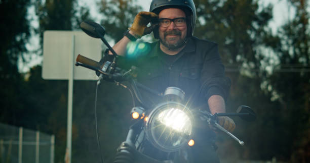 istock Motorcyclist Adjusts Glasses 1307283135