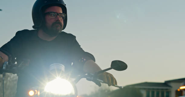 istock Helmeted Motorcyclist  Regards His Left 1307283136
