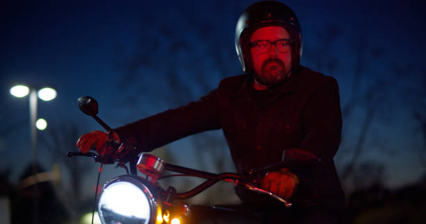 istock Lone Motorcyclist Mid-Turn Looks Left 1307283150
