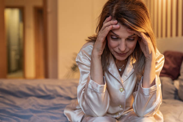 istock Mature woman in bedroom, feeling sad 1307283592