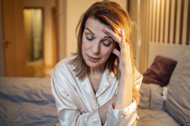 istock Mature woman in bedroom, feeling sad 1307284604