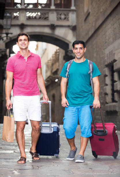 istock Men tourists walking with suitcases 1307285750