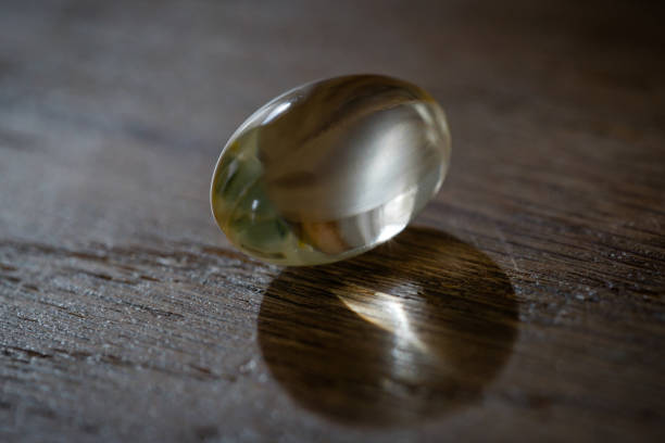 istock Back lit macro close-up of a single transparent pill 1307285987