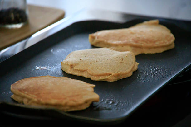 Hot pancakes on a griddle a picture of Hot pancakes on a griddle griddle stock pictures, royalty-free photos & images