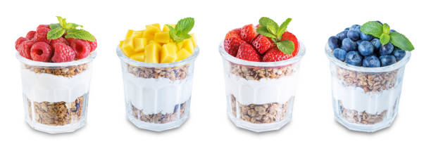 Set of Greek yogurt granola parfaits with strawberries, blueberries, mango fruits and raspberries in a glass on a white isolated background Set of Greek yogurt granola parfaits with strawberries, blueberries, mango fruits and raspberries in a glass on a white isolated background. toning. selective focus yogurt parfait stock pictures, royalty-free photos & images