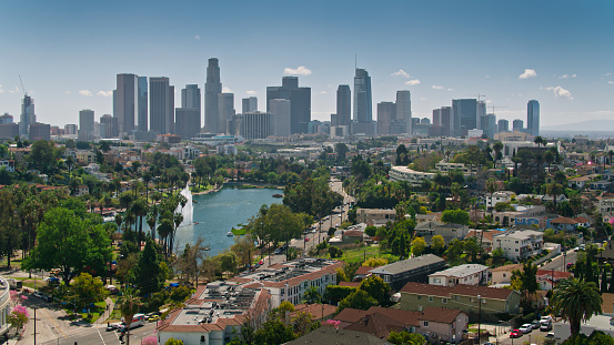 Aerial view of Echo Park Lake looking towards the looming towers of the downtown Los Angeles skyline.