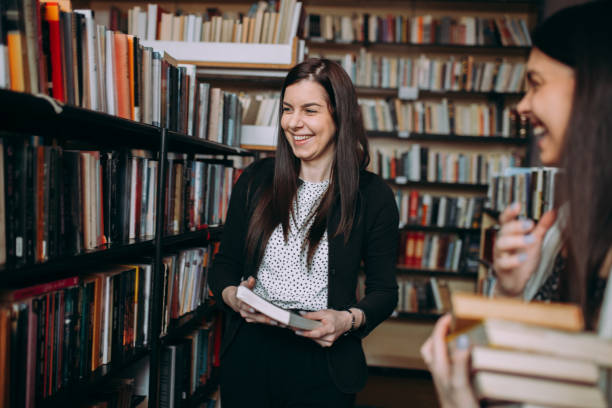 istock Two female students read and learns by the book shelf at the library 1307288289