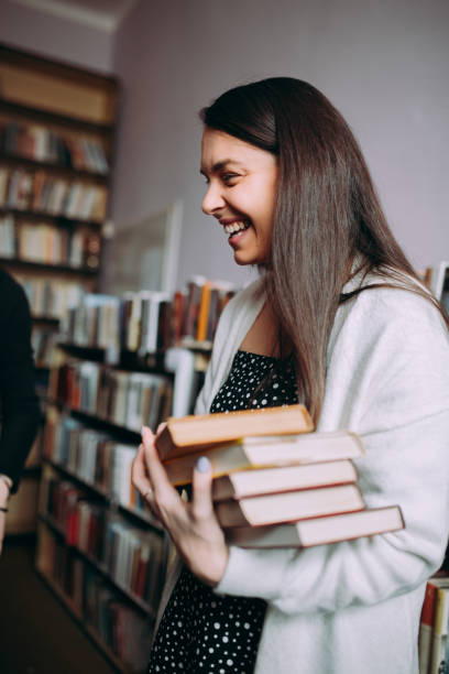 istock Two female students read and learns by the book shelf at the library 1307288453