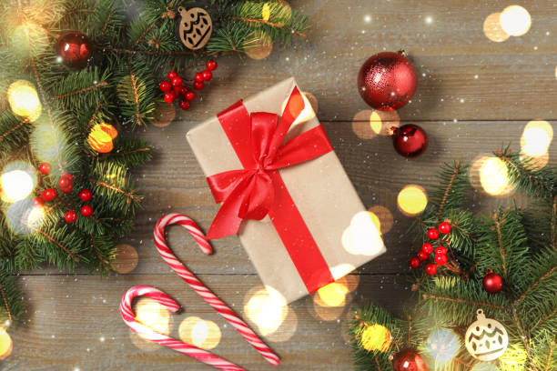 istock Flat lay composition with Christmas gift box and decor on wooden table 1307290593