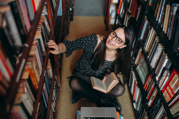 istock Young woman studying in the library 1307292465