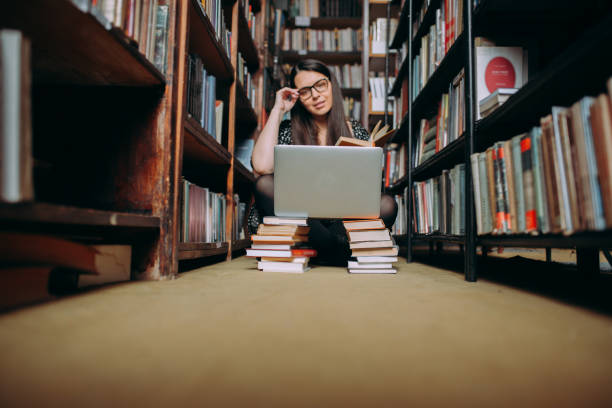 istock Young woman studying in the library 1307292544