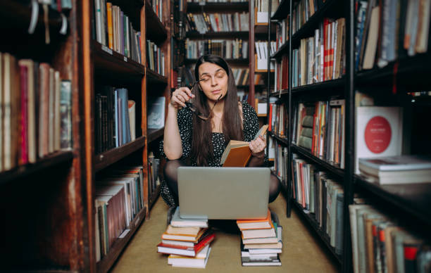 istock Young woman studying in the library 1307292652