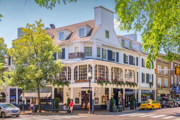 People stand in front of a restaurant in downtown State College Pennsylvania USA on a sunny day.