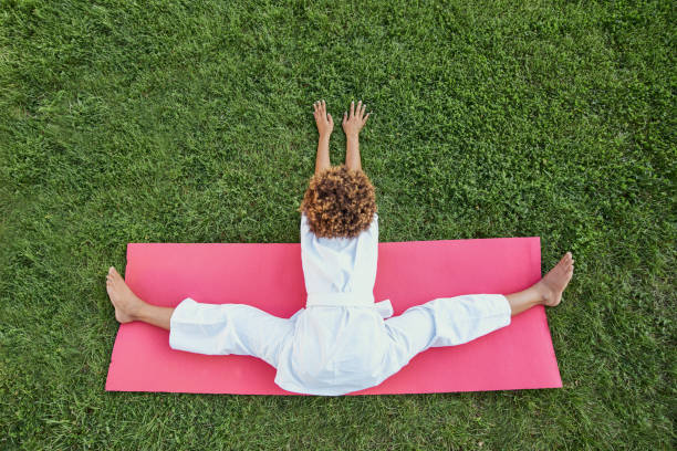 istock Afro American girl karateka doing exercise on green lawn 1307295207