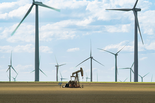 Solo Oil Derrick Stands Among Modern Windmills in Genoa, CO, United States