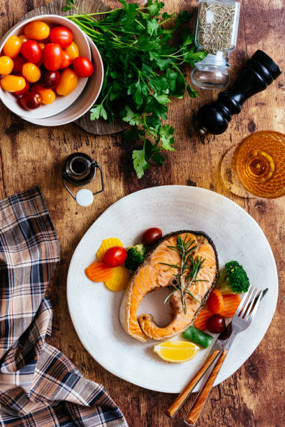 istock grilled salmon steak with vegetables on a wooden table 1307297168