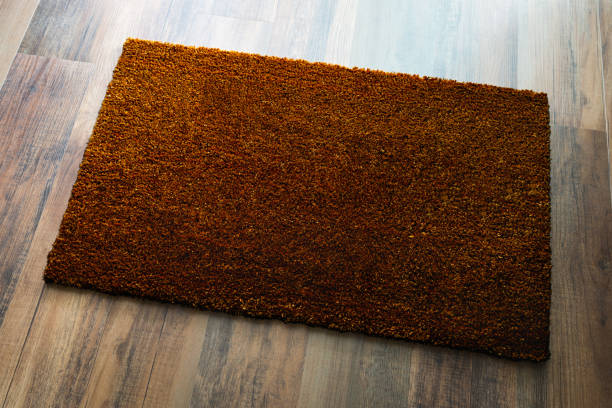 istock Blank Dark Brown Welcome Mat On Wood Floor Background Ready For Your Own Text 1307299042