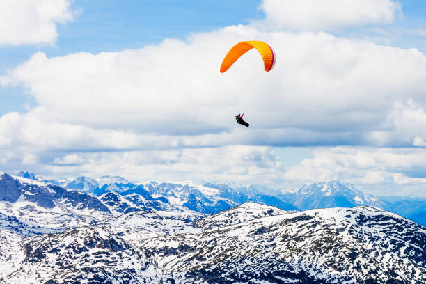 Paraglider in the Dachstein Alps Mountains in Salzkammergut region, Austria view from Five Fingers viewpoint