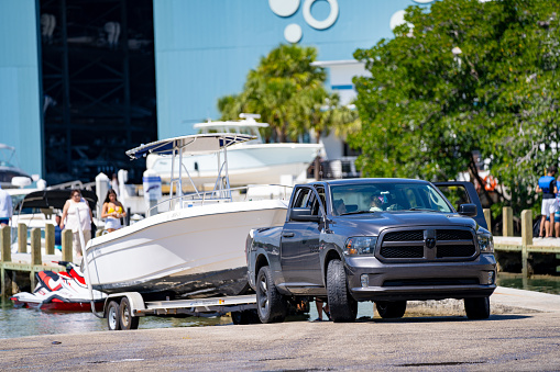 Miami, FL, USA - March 13, 2021: Front view of a Dodge truck loading a boat into the water