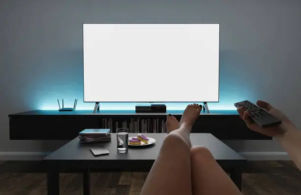 Photo of girl watching TV mockup in living room with modern lighting