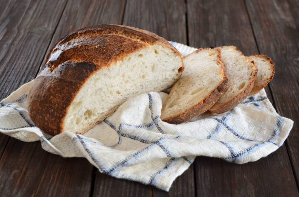 istock Sliced homemade bread on a kitchen towel 1307301598