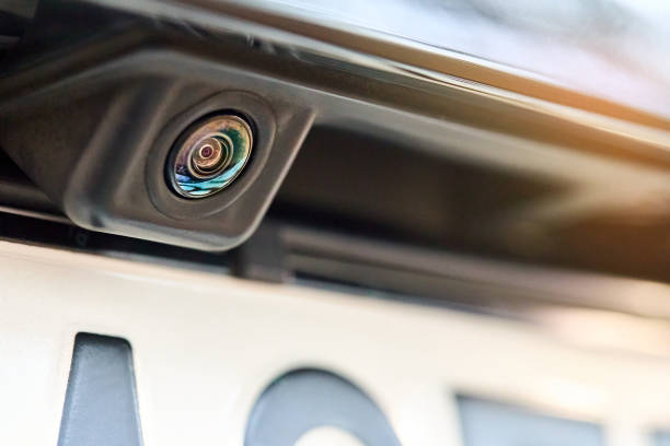 istock Luxury car rear view camera for parking assistance selective focus close up with sunflare and copyspace. Concept of safety car driving while parking process. Assist device equipment in modern cars. 1307303224