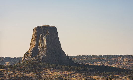 This is a photograph of the natural landmark, Devil’s Tower a National Monument in Wyoming, USA on a sunny September day.